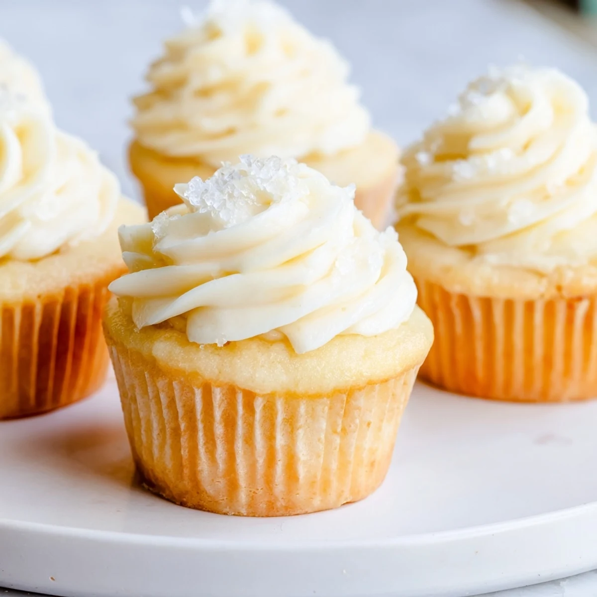 Fluffy vanilla cupcakes, frosted generously with creamy buttercream, ready to enjoy.