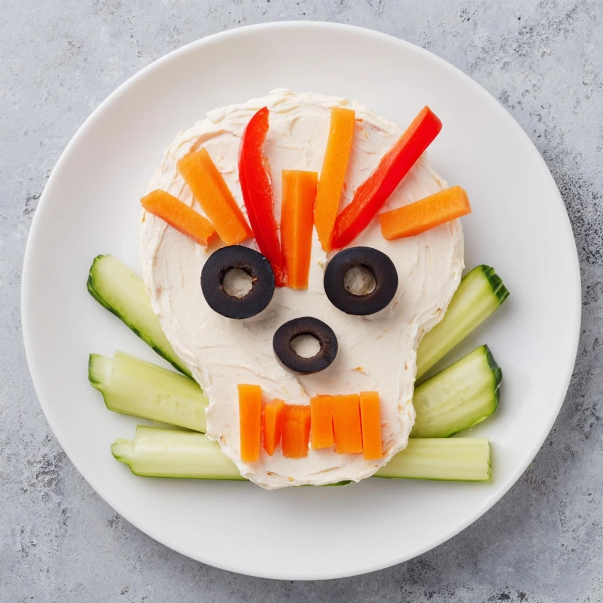 The Skull & Bones Spooky Spread features a creamy skull shape with olive eyes and carrot teeth, delicious!