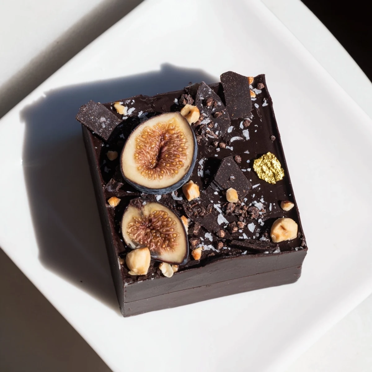 Close-up view of The Midnight Mosaic shows a decadent dessert with figs, olives, and chocolate.