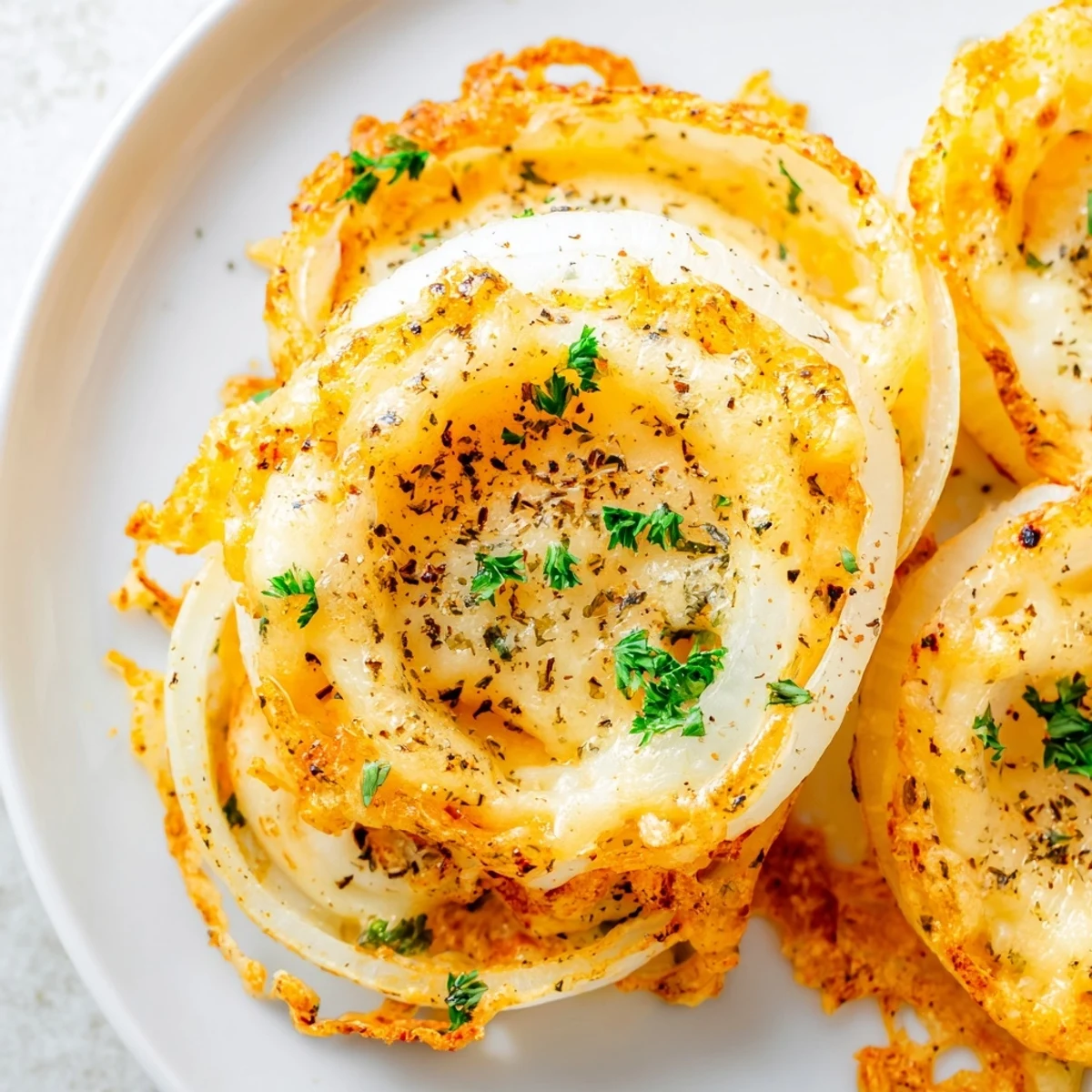 Air-fried Crispy Onion Cheese Chips, a savory appetizer; individual onion rings with a cheesy, crispy texture.