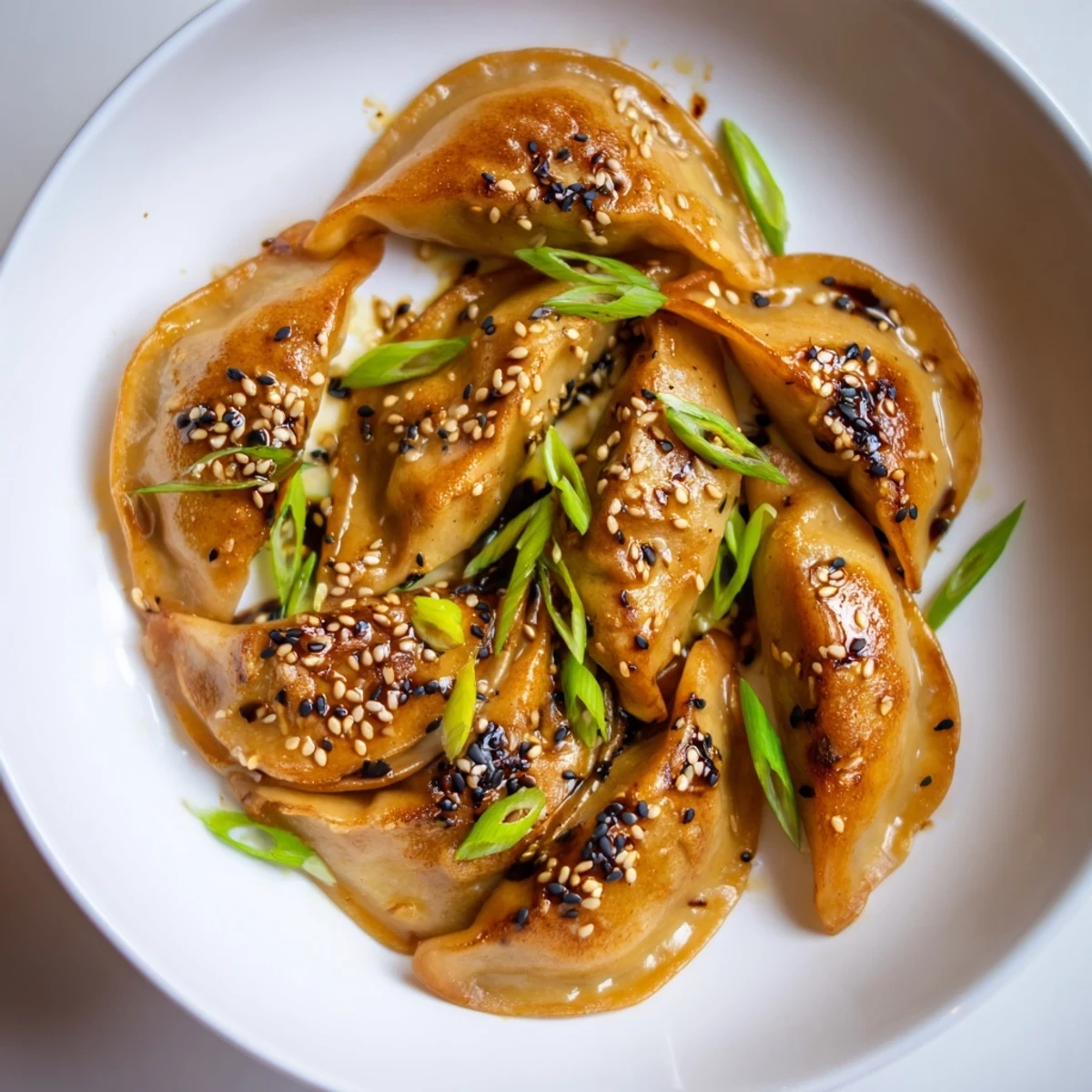 Golden-brown air fryer frozen dumplings glistening with a savory sesame oil glaze, ready to serve.