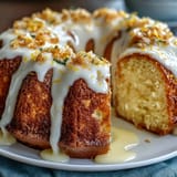 Golden, buttery Limoncello cake infused with citrus and drizzled with glossy lemon glaze for a vibrant, indulgent finish.  