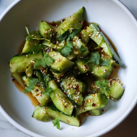 Vibrant Chinese Spicy Smashed Cucumber Salad: Cool green cucumbers tossed in a spicy, sesame-infused dressing.