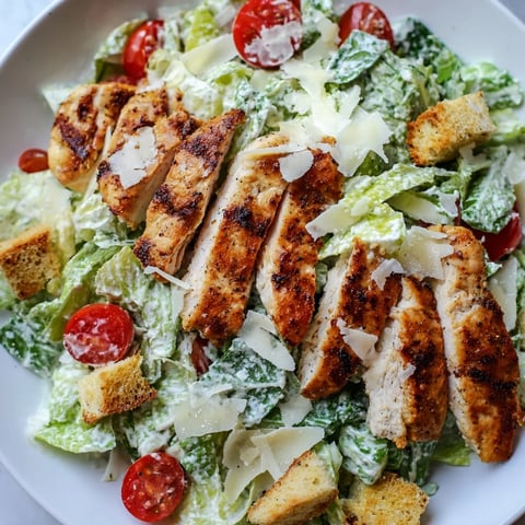 Freshly grilled chicken strips layered over crisp romaine lettuce for a satisfying Yogurt Caesar Grilled Chicken Salad.