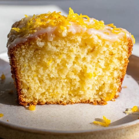 Freshly baked lemon loaf, beautifully iced, a perfect dessert for any occasion, looks delicious.