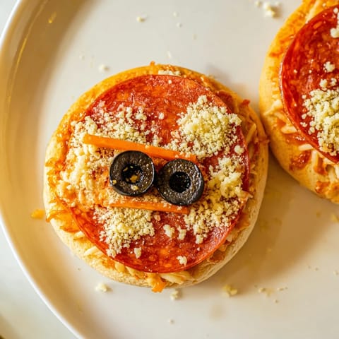 Santa Belt Mini Pizza Bites with melted mozzarella cheese and pepperoni "belts," festive party food.