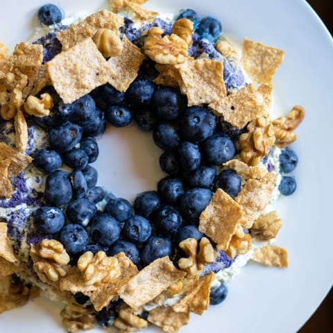 A close-up of The Olympic Rings Interlock platter showcasing colorful fruits and cheeses, ready for guests.