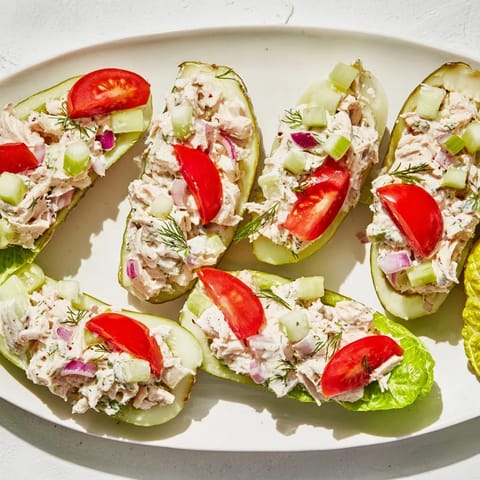 A close-up of a loaded pickle sandwich highlighting the creamy chicken salad inside.