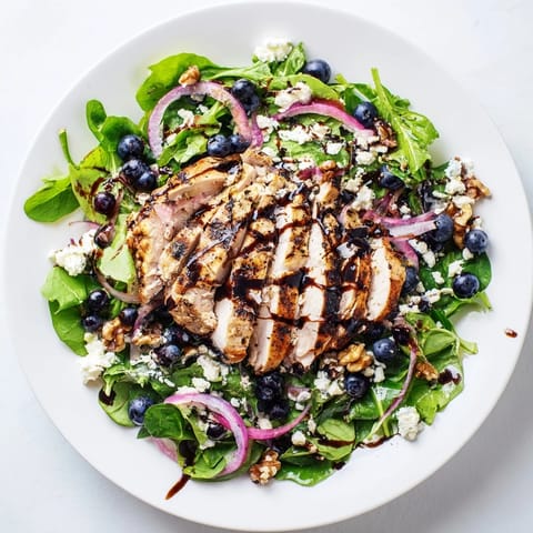 A beautiful close-up shows the colorful Blueberry Goat Cheese Chicken Salad, ready for a delicious lunch.
