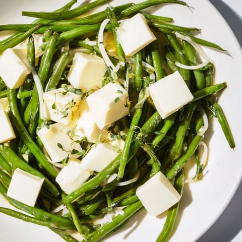 Freshly tossed English Ivy salad, with tender snap peas, green beans and creamy cheese, ready to serve.