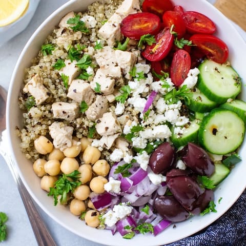 A vibrant, healthy Mediterranean Chicken Bowl served with feta, chickpeas, and a zesty lemon-oregano dressing.
