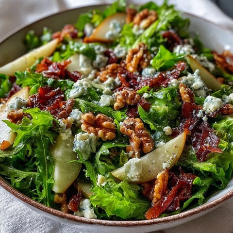 Walnuts and blue cheese crumbles garnish the vibrant Frisée Pear Blue Cheese Bowl salad.