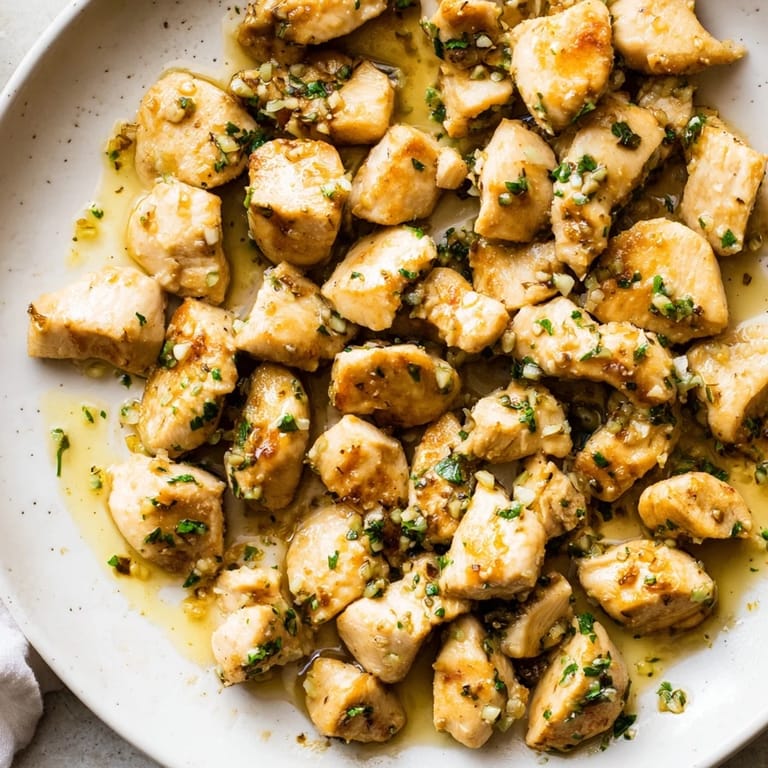 Close-up of Garlic Butter Chicken Bites, coated in a rich, buttery sauce, ready for a delicious dinner.