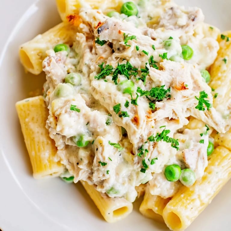 A comforting, steaming bowl of Slow Cooker Chicken Alfredo Pasta Bake, perfect for a cozy dinner.
