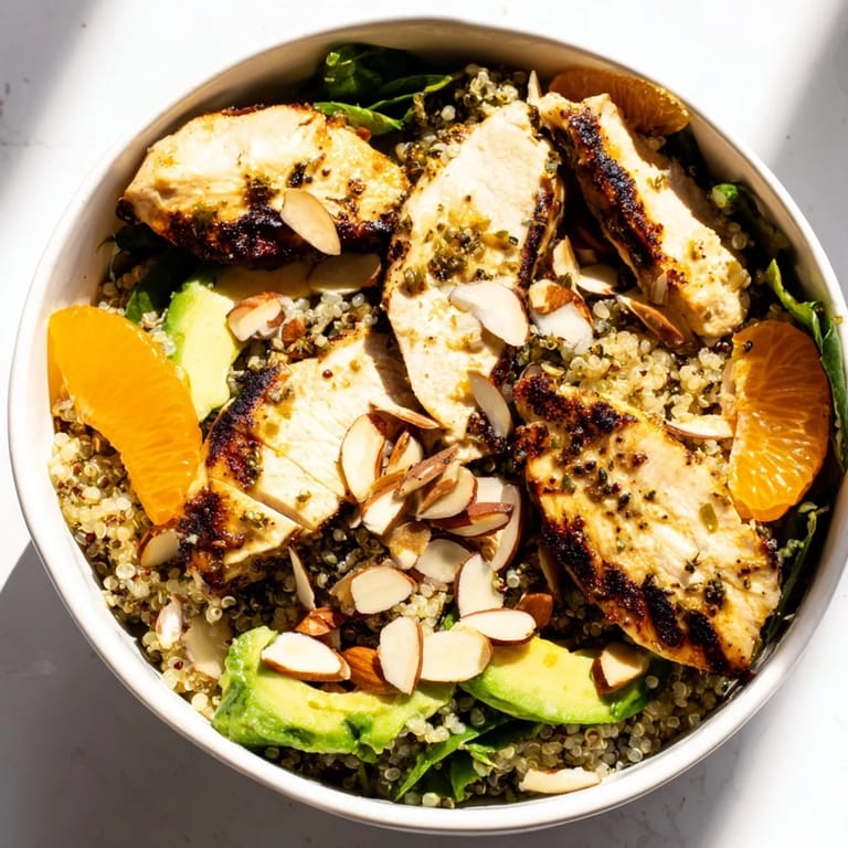 Serve this flavorful Citrus Herb Chicken Salad Bowl with toasted almonds, bright orange segments, and a light citrus vinaigrette over fluffy quinoa and greens.
