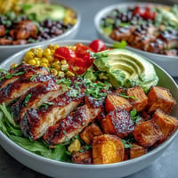 Juicy grilled BBQ chicken meal prep bowls with tender sweet potato and vibrant veggies.